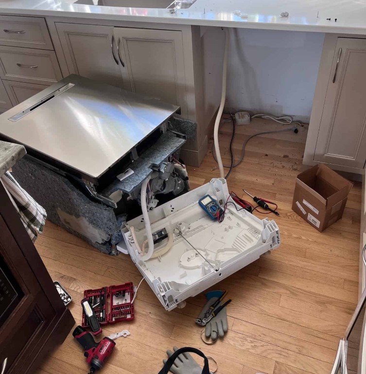 Bestcare engineer servicing the spray arm of a dishwasher in a Nairobi kitchen
